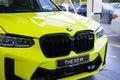 close-up yellow BMW 5-door petrol crossover model X3 M in Studio, Exterieur vehicle in showroomr, German brand automotive