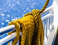 Yellow braided rope draped over a ship railing Royalty Free Stock Photo