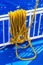 Yellow braided rope draped over a ship railing Royalty Free Stock Photo