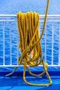 Yellow braided rope draped over a ship railing Royalty Free Stock Photo