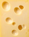 Close Up Yellow Cheese Block with Irregular Holes Top View in Studio Light Royalty Free Stock Photo
