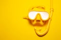 Close-up of yellow diving mask with snorkel, on background of yellow color with copy space. Royalty Free Stock Photo