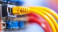 Close up of yellow ethernet cable plugging into terminal block, with red and yellow cables blurred in background Royalty Free Stock Photo