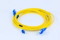 Close Up of Yellow Fiber Optic Cable with Blue Connectors Royalty Free Stock Photo