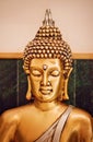 Close up yellow-gold statue Buddha in meditation