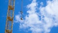 Close up of a yellow and green crane boom with main block and jib against a clear blue sky. Tower building cranes Royalty Free Stock Photo