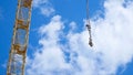 Close up of a yellow and green crane boom with main block and jib against a clear blue sky. Tower building cranes Royalty Free Stock Photo