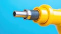 Close-up of a yellow industrial tool component against a blue background, showcasing precision engineering and modern technology Royalty Free Stock Photo