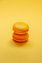 Close up of yellow macaroons over yellow background. Royalty Free Stock Photo