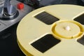 Close-up of a yellow magnetic tape reel, on an old tape recorder Royalty Free Stock Photo