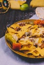 close up yellow mexican nachos plate butter paper. High quality photo