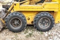 Close-up of a yellow mini excavator wheel on a construction site Royalty Free Stock Photo