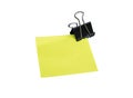 Close-up Yellow note and black clip isolated on white background Royalty Free Stock Photo