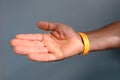 Close-up of yellow paper bracelet, check tape with entry number on hand of middle-aged european man, event ticket concept Royalty Free Stock Photo