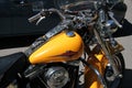 Close up of yellow parked Harley-Davidson motorcycle.