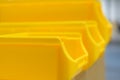 Close up of yellow plastic parts bins Royalty Free Stock Photo