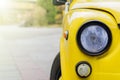 Close up of yellow retro car with round headlights Royalty Free Stock Photo