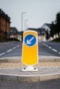 Close up of yellow road crossing sign on pedestrian refuge island in the UK Royalty Free Stock Photo