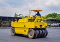 Close up of Yellow Road roller, Male workers are driving a road