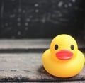 Close up of yellow rubber duck on black background created using generative ai technology Royalty Free Stock Photo