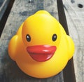 Close up of yellow rubber duck on wooden background created using generative ai technology Royalty Free Stock Photo