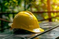 Close up of yellow safety helmet on table at construction site, emphasizing safety equipment Royalty Free Stock Photo