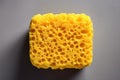 Close-up of a yellow sponge, an effective household cleaner for various tasks in the bathroom and kitchen