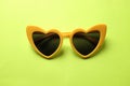 Close up yellow sunglasses isolate on a green background