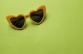 Close up  yellow sunglasses isolate on a green background Royalty Free Stock Photo