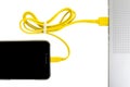 Close-up yellow usb cable connect phone and laptop computer new technology concept Royalty Free Stock Photo