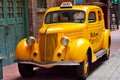 Close up of a yellow vintage taxi car