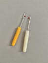 Close up Yellow and white quick unpick sewing tools on the table