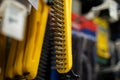 Close up of yellow wire brush hanging in hardware store Royalty Free Stock Photo