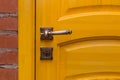 Close-up yellow wooden door metal handle object detail interior indoor Royalty Free Stock Photo