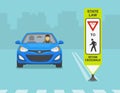 Close-up of a `Yield to pedestrians within crosswalk` sign. Blue sedan car is approaching the crosswalk. Royalty Free Stock Photo