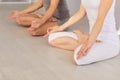 Close up of yoga couple people hand sitting relaxation in lotus field on floor in studio class. Royalty Free Stock Photo