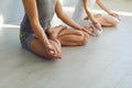 Close up of yoga couple people hand sitting relaxation in lotus field on floor in studio class. Royalty Free Stock Photo