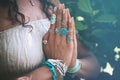 close up of yoga woman hands in namaste gesture with lot of boho style jewelry rings and bracelets outdoor Royalty Free Stock Photo