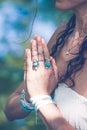 close up of yoga woman hands in namaste gesture with lot of boho style jewelry rings and bracelets outdoor Royalty Free Stock Photo