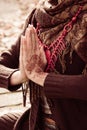 Close up of yoga woman hands in namaste gesture with henna drowing on hands outdoor shot