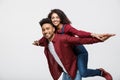 Close-up young african american couple riding back and playing like plane. Royalty Free Stock Photo