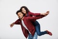 Close-up young african american couple riding back and playing like plane. Royalty Free Stock Photo