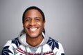 Close up young african american man smiling against gray background Royalty Free Stock Photo