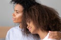 Close up young African American mother hugging teen daughter Royalty Free Stock Photo