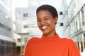 Close up young african american woman smiling outside in city Royalty Free Stock Photo