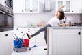 Woman Slipping While Mopping Floor In Kitchen Royalty Free Stock Photo