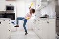 Woman Slipping While Mopping Floor In Kitchen Royalty Free Stock Photo