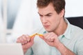 Close up of young angry businessman breaking Royalty Free Stock Photo