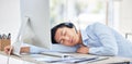 Close up of young asian businessman feeling tired and sleeping on the desk of a call center in a office. Male wearing Royalty Free Stock Photo