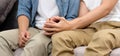 Close up of young asian gay man couple holding hands with happiness while sitting in home living room, homosexual and lgbt